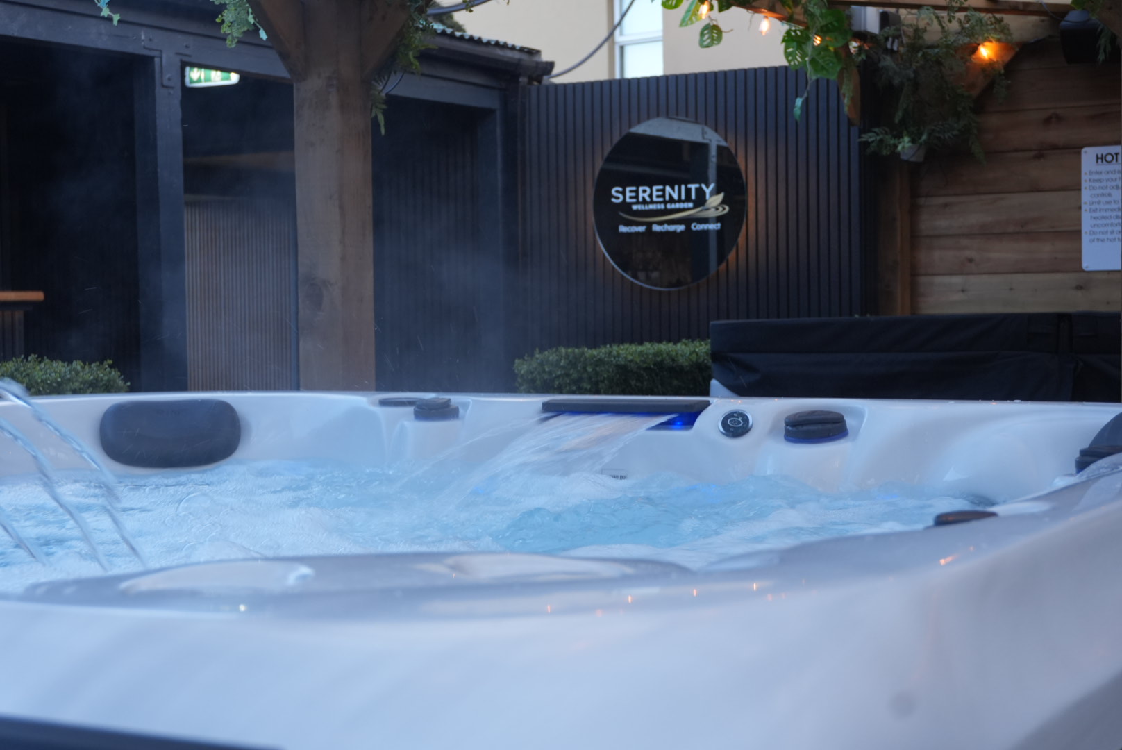 Steaming luxury hot tub at Serenity Wellness Garden